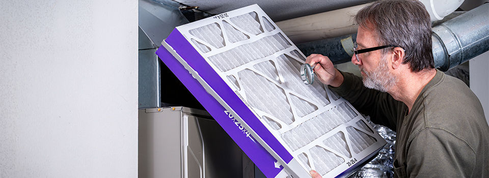 Furnace filter inspection with a magnifying glass