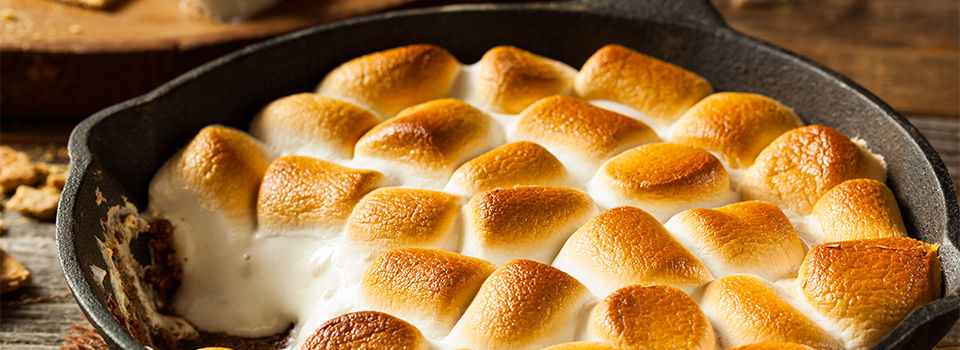 A cast iron skillet full of marshmallows