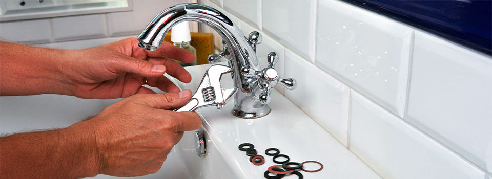 A plumber repairing a faucet