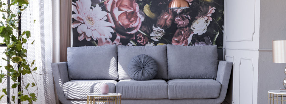 wallpaper on wall with a couch in front of it