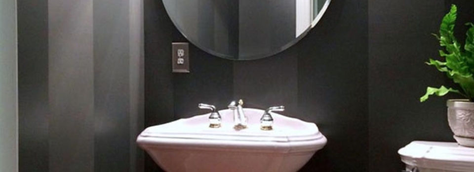 Bathroom sink against a dark colored wall
