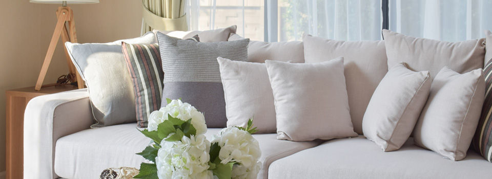 Grey living room with a couch with lots of pillows