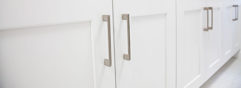 White kitchen cabinets with silver hardware