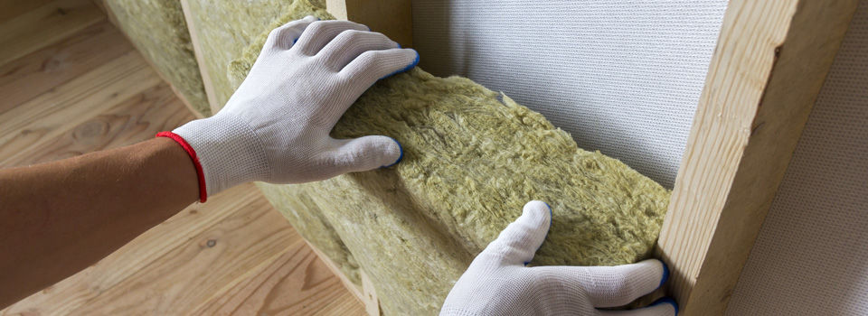 a person insulating basement walls
