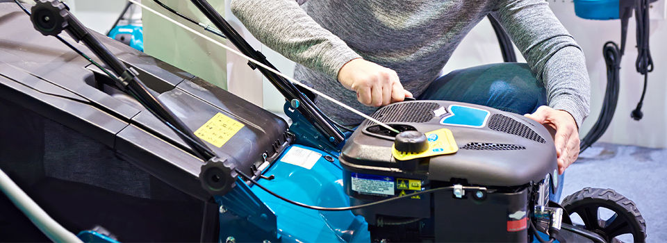 A man choosing a lawn mower in a store 