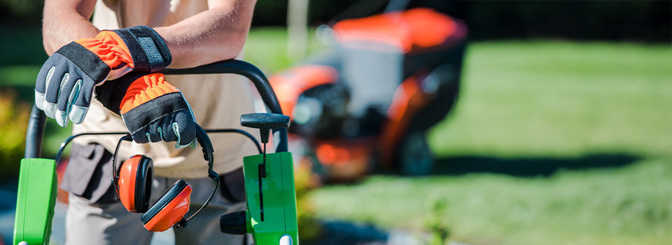 Landscaping Contractor Work. Caucasian Gardener with His Equipment.