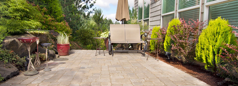 Brick patio and rock garden replacing grass lawn