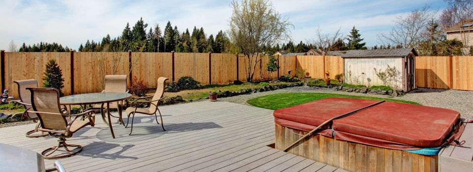 Wood patio framed by minimal landscaping and no grass lawn
