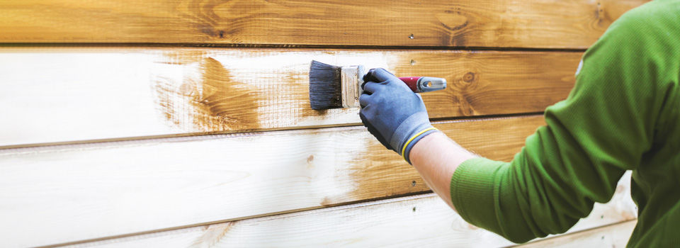 wood siding being painted brown