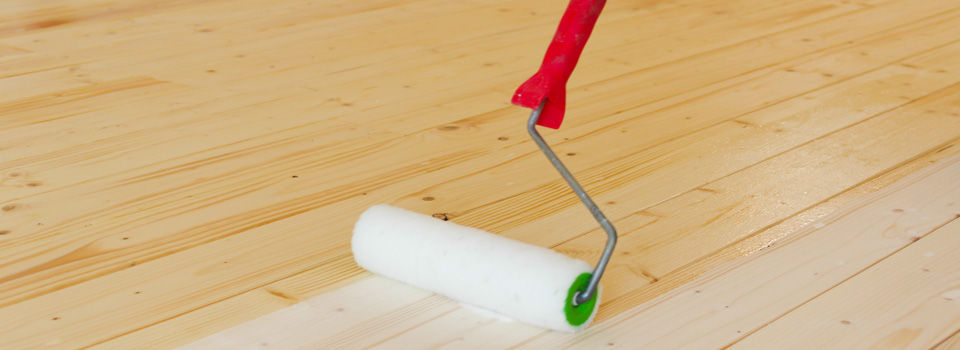 paint roller on hardwood floor