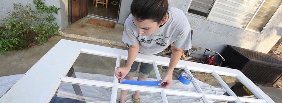 A woman repainting a door