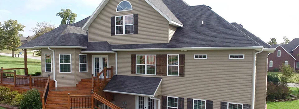 Back of a beige three story house 