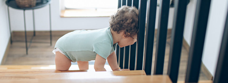Kid on the stairs near the banister