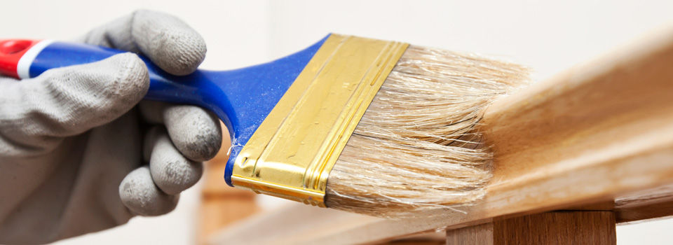 Person staining banister from a different angle