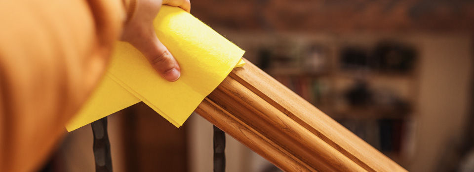 Person cleaning banister