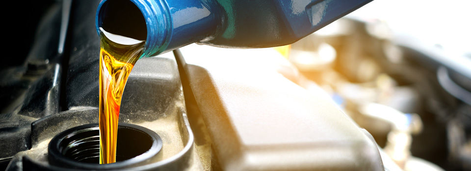 motor oil being poured into an engine