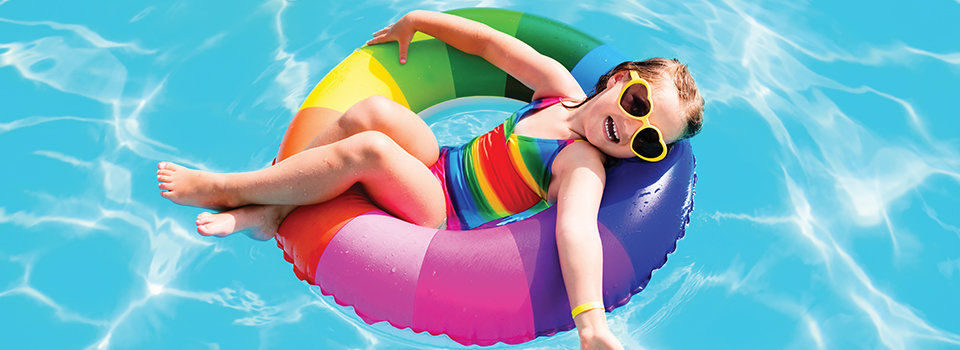 Little girl in a pool floating in an inner tube 