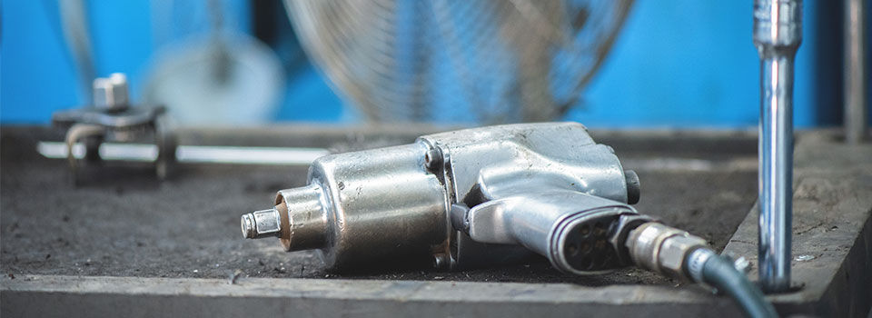 Air tool sitting on top of workbench