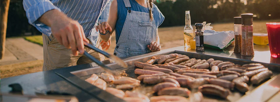 Man cooking on a griddle in the backyard