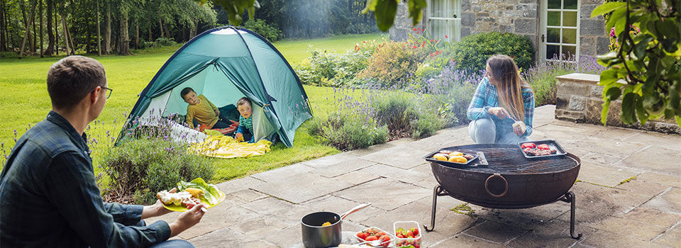 A family enjoying backyard camping