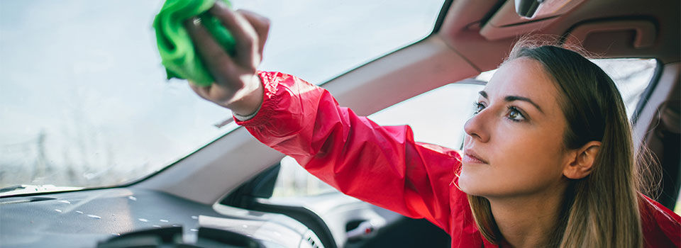 a young woman cleaning and detailing her car