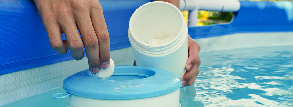 Putting chlorine tablet into the pool