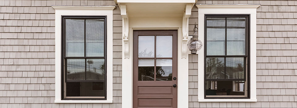 Front door with screened windown on either side