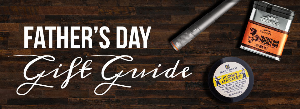 Father's Day Gift Guide text on top of a wooden background with Traeger Rub, a Flashlight, and Duke Cannon Bloody Knuckles 