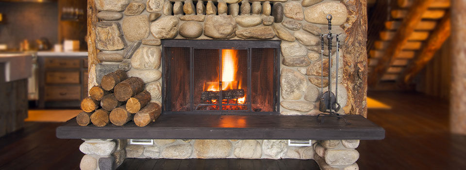 Fire logs burning in a stone fireplace