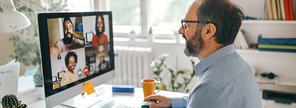 Man working from home in a virtual meeting with colleagues