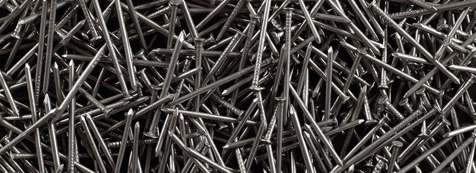 A heap of silver nails laying in a pile