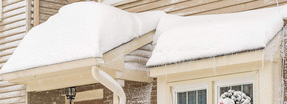 Snow piled on the roof of a house