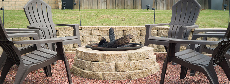 Fire pit in backyard surrounded by chairs