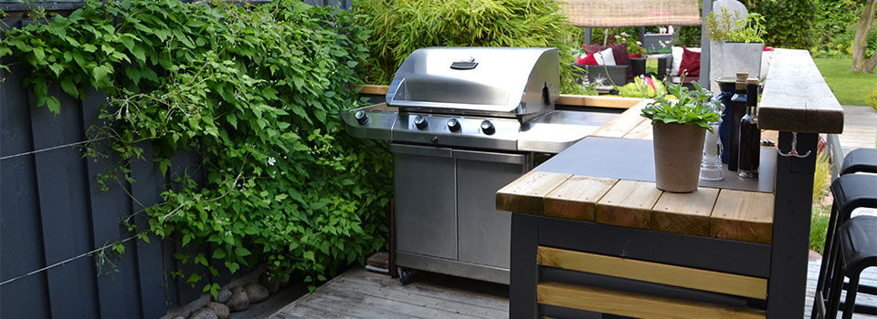Outdoor kitchen with a stainless gas grill