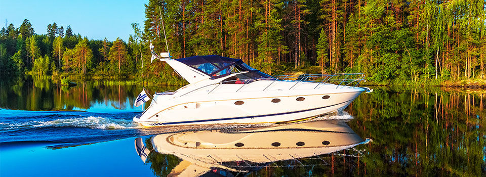 Scenic summer view of recreational yacht sailing by the lake water landscape among islands with deep forests in Finland