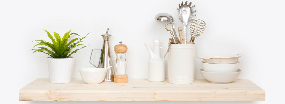 A floating shelf with kitchen items on it