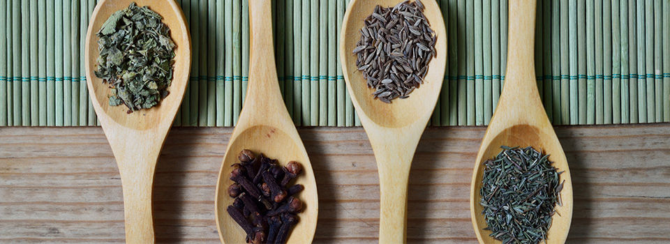 Wooden spoons with different herbs and spices