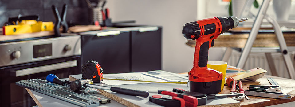 Kitchen countertop strewn with tools for a home improvement project