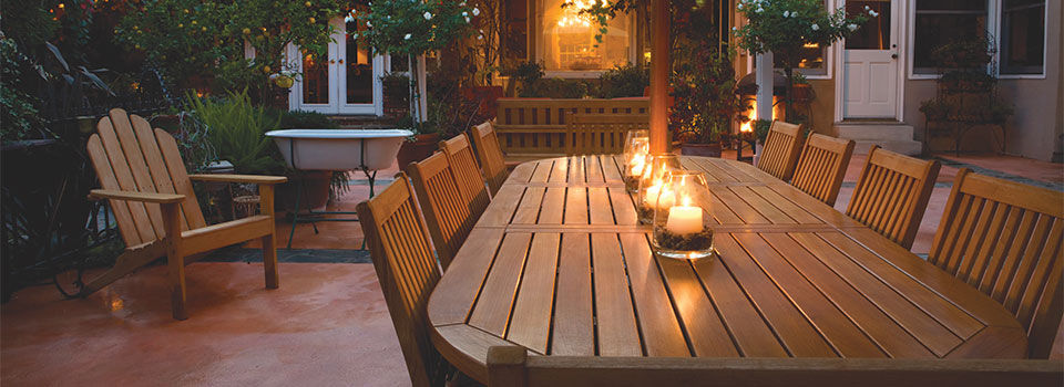 Candles lit on a patio table outside