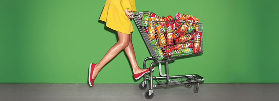 Person pushing a shopping cart full of pringles