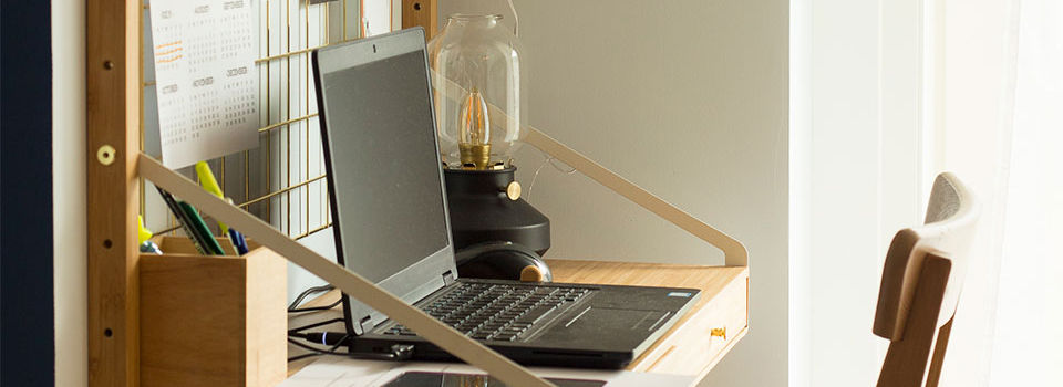 Laptop open on a space saving desk