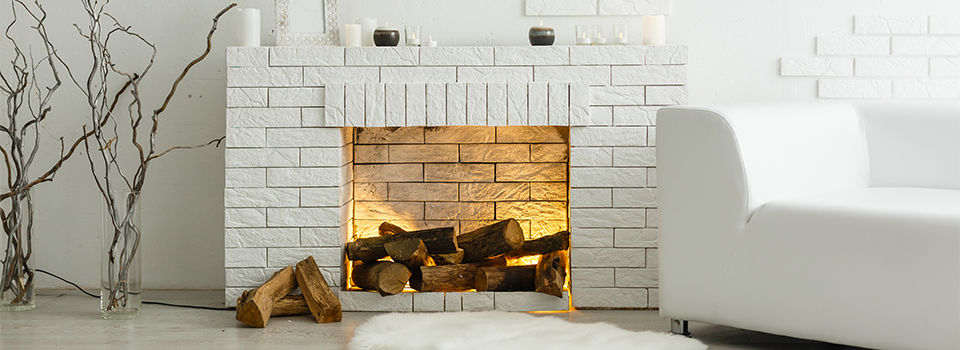 White fireplace in light room with Christmas decoration 