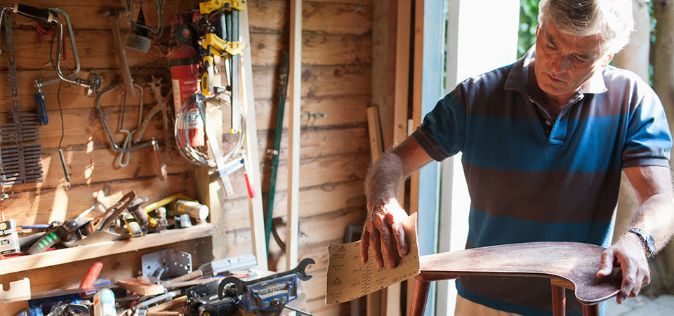 A mna wood working in his garage