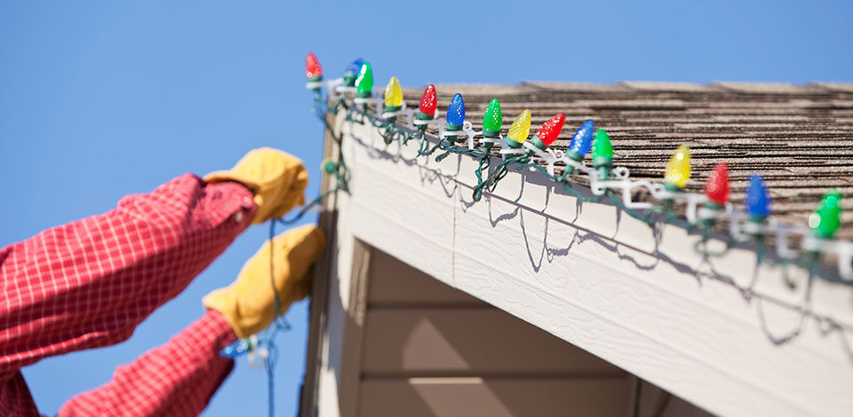 Using clips to hang Christmas lights