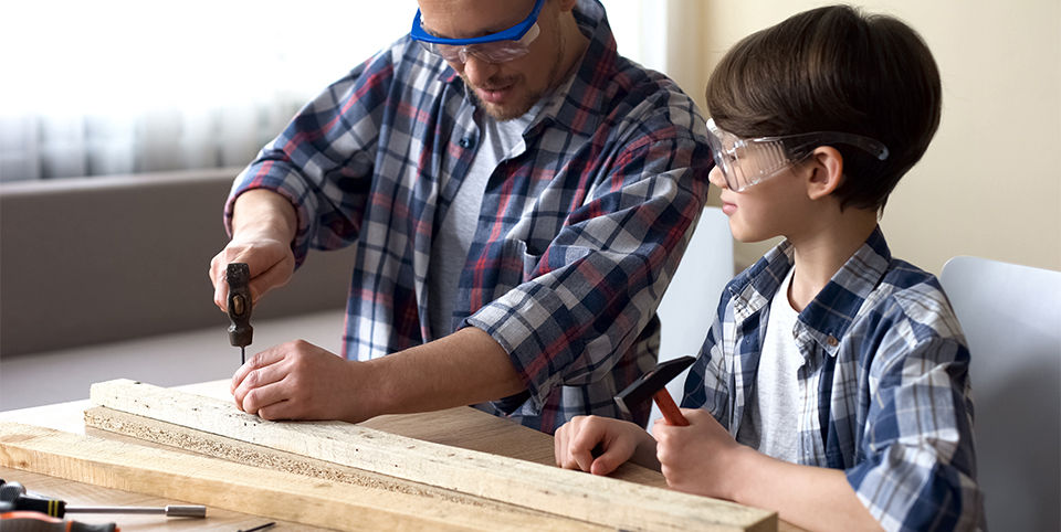 Father and son working on a workbench