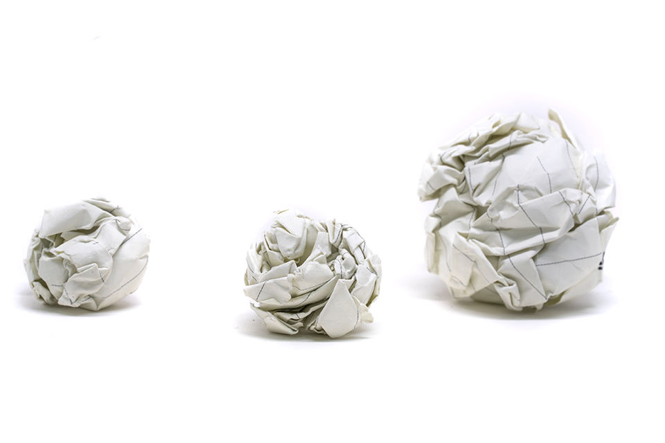 Three crumpled up paper snow balls.