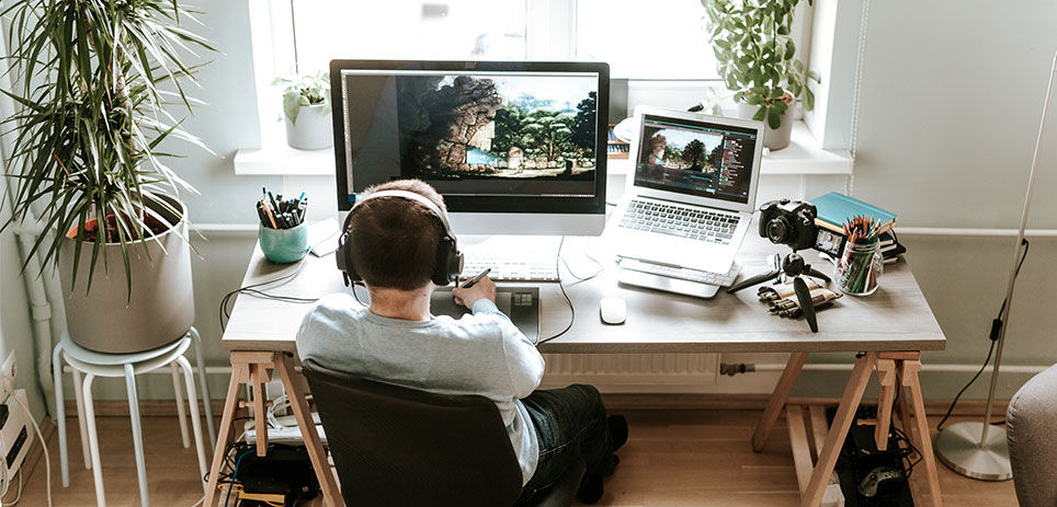 Man with headphones on working at his desk 