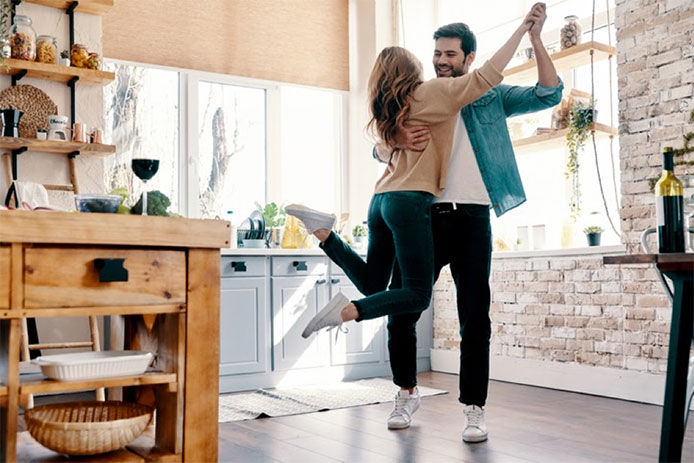 Couple dancing in the kitchen together