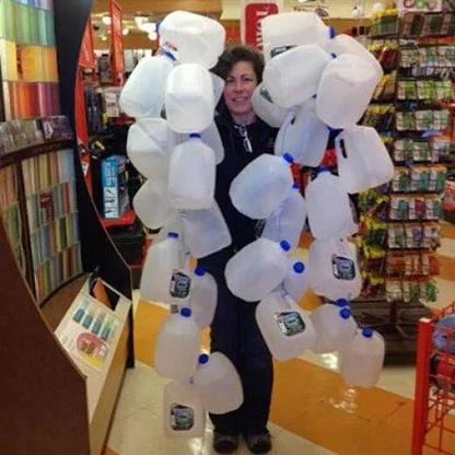 Patti holding multiple empty gallon jugs