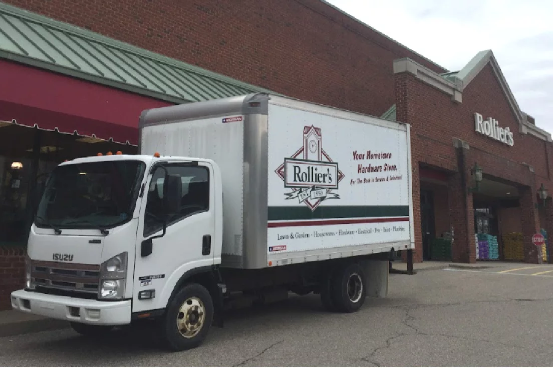 Rollier delivery truck parked in front of store